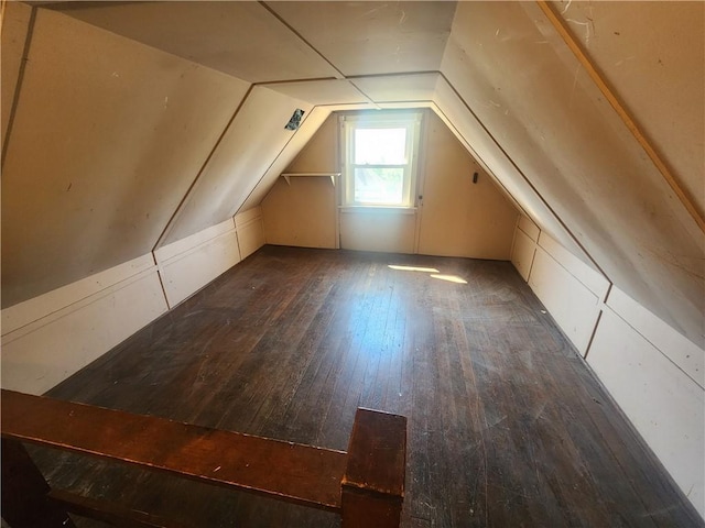additional living space featuring hardwood / wood-style flooring and lofted ceiling