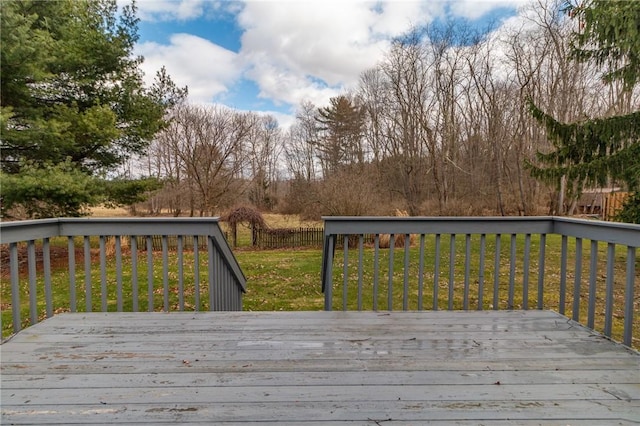 wooden deck with a lawn