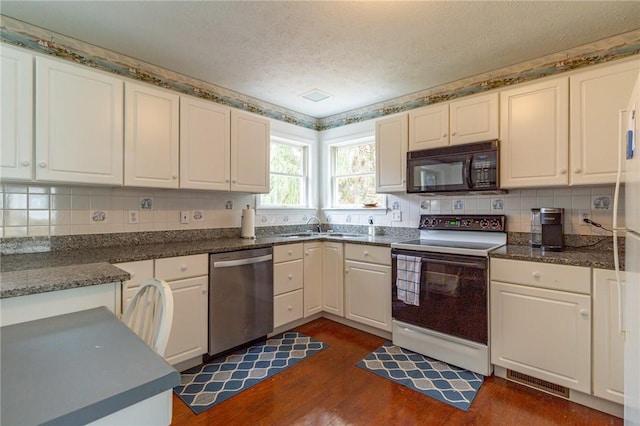 kitchen featuring range with electric cooktop, dishwasher, dark wood-type flooring, black microwave, and decorative backsplash