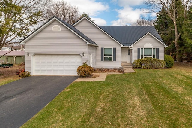 ranch-style home with metal roof, an attached garage, a front lawn, and aphalt driveway
