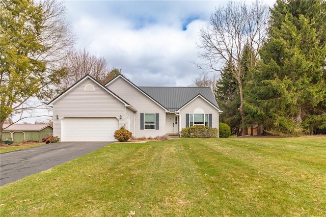 ranch-style home with a front lawn, metal roof, aphalt driveway, and a garage