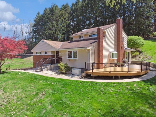 rear view of property with a lawn, a wooden deck, and a chimney