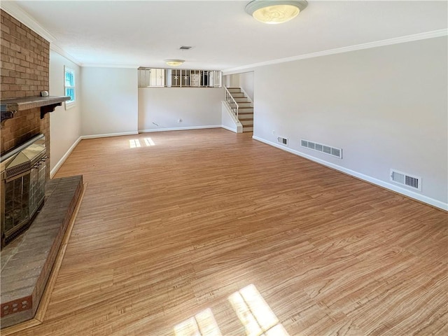 1248 Satellite Cir, Upper St Clair, PA 15241 - unfurnished living room with a brick fireplace, crown molding, light wood-type flooring, and stairs