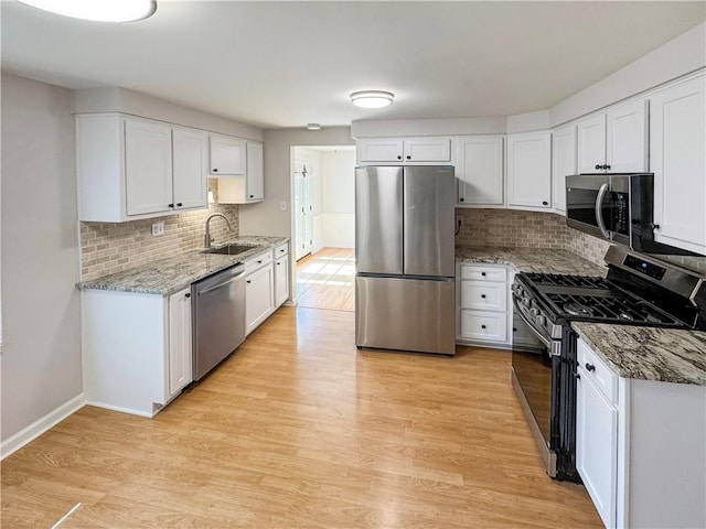 1248 Satellite Cir, Upper St Clair, PA 15241 - kitchen with appliances with stainless steel finishes, white cabinetry, backsplash, and light stone countertops