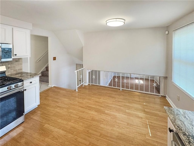 1248 Satellite Cir, Upper St Clair, PA 15241 - kitchen featuring appliances with stainless steel finishes, light wood-style flooring, light stone countertops, and white cabinetry