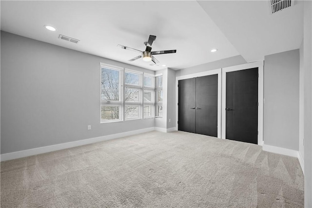 unfurnished bedroom featuring baseboards, visible vents, recessed lighting, and carpet flooring