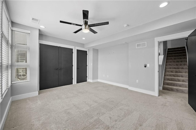 unfurnished bedroom with carpet, baseboards, and visible vents