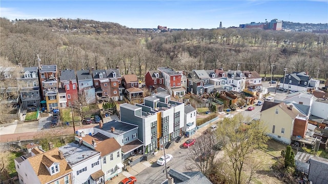 bird's eye view featuring a wooded view and a residential view