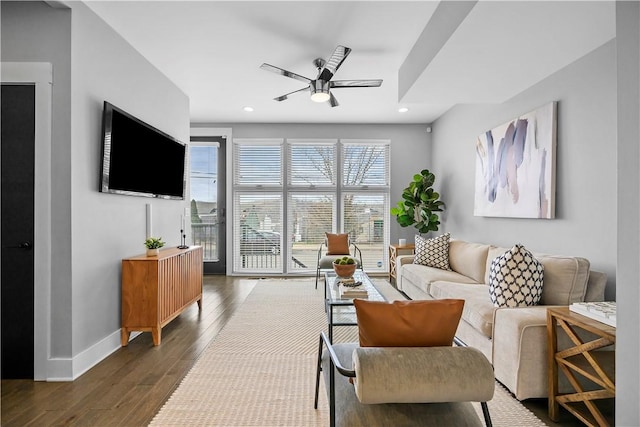 living area with baseboards, wood finished floors, ceiling fan, and recessed lighting