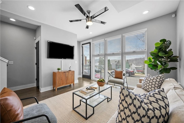 living area featuring baseboards, ceiling fan, wood finished floors, and recessed lighting