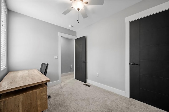 office area featuring baseboards, visible vents, carpet floors, and a ceiling fan