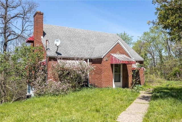 321 Apache Dr, Monessen, PA 15062 - back of house with a chimney, brick siding, and roof with shingles