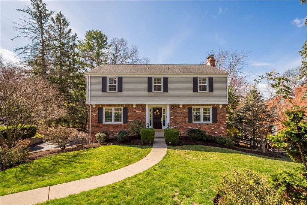 119 Seegar Rd, Upper St Clair, PA 15241 - colonial house featuring brick siding, a front yard, and a chimney
