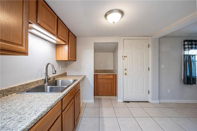 719 Zimmerman St, Jeannette, PA 15644 - kitchen with light tile patterned floors, light countertops, and brown cabinetry