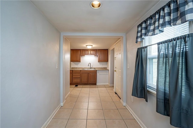 719 Zimmerman St, Jeannette, PA 15644 - kitchen with light countertops, light tile patterned flooring, and brown cabinetry