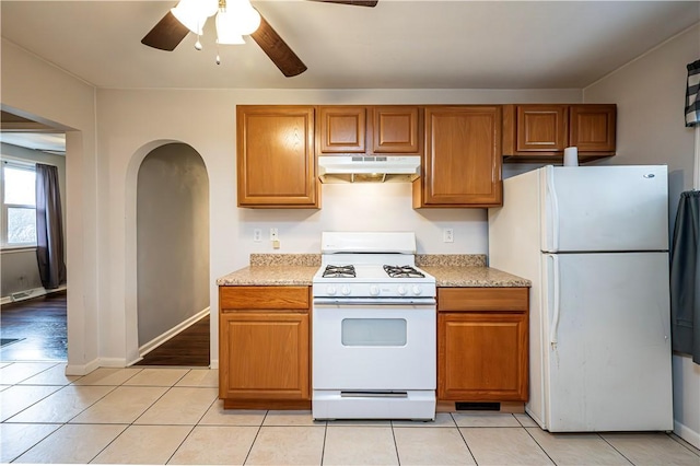 719 Zimmerman St, Jeannette, PA 15644 - kitchen featuring white appliances, under cabinet range hood, a ceiling fan, and light countertops