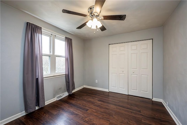 719 Zimmerman St, Jeannette, PA 15644 - unfurnished bedroom with dark wood-style flooring, a ceiling fan, and a closet