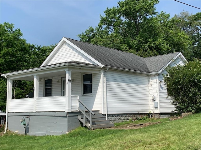 719 Zimmerman St, Jeannette, PA 15644 - view of front of property with a porch, a shingled roof, and a front lawn