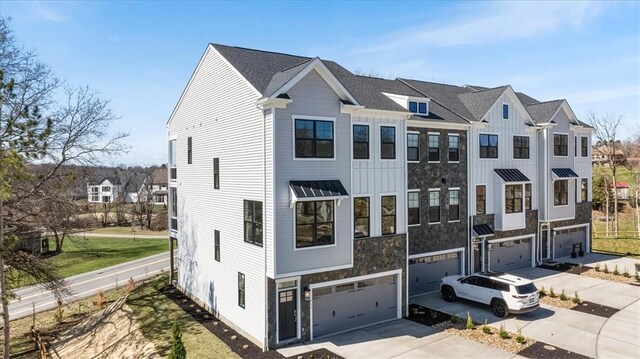 111 Quail Run Rd Unit 1, Peters Twp, PA 15367 - multi unit property with an attached garage, driveway, board and batten siding, a residential view, and stone siding