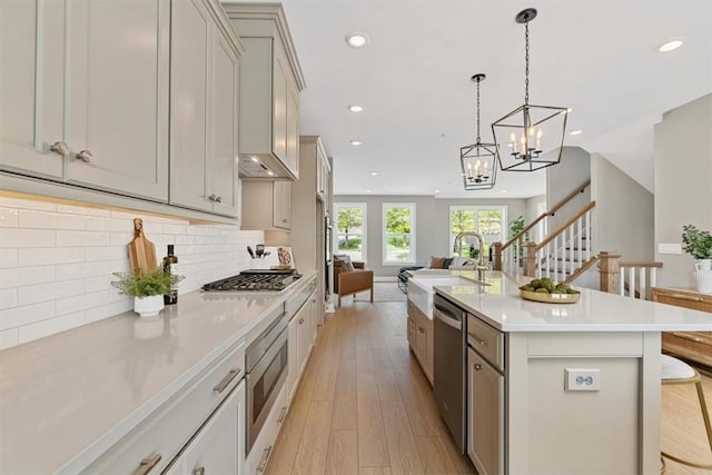 111 Quail Run Rd Unit 1, Peters Twp, PA 15367 - kitchen featuring open floor plan, appliances with stainless steel finishes, recessed lighting, light wood finished floors, and light countertops