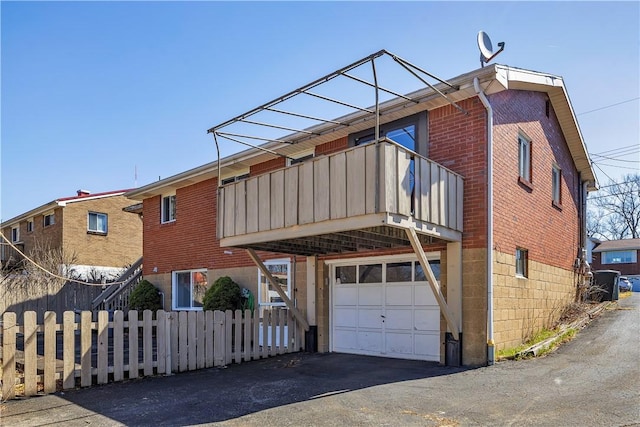 614 Tartan Dr, Monroeville, PA 15146 - view of front of home with a balcony, fence, an attached garage, brick siding, and driveway