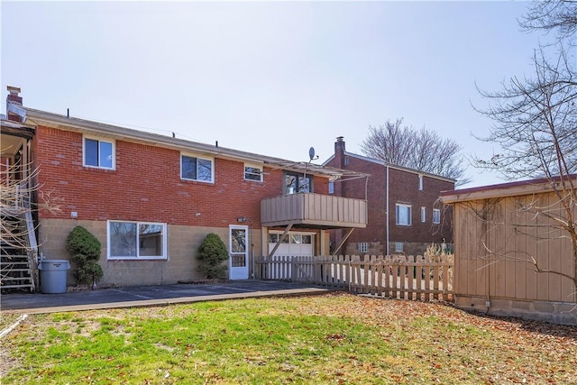 614 Tartan Dr, Monroeville, PA 15146 - back of house featuring a yard, brick siding, a balcony, and fence