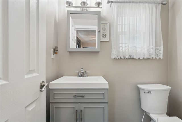 bathroom with toilet and vanity