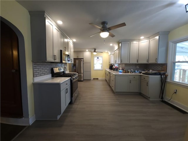 418 Pine Hill Rd, W Kittanning Boro, PA 16201 - kitchen with a ceiling fan, wood finished floors, decorative backsplash, baseboards, and appliances with stainless steel finishes