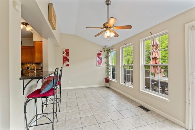 505 Luke Ct, Cranberry Twp, PA 16066 - dining room featuring a ceiling fan, vaulted ceiling, light tile patterned floors, and baseboards