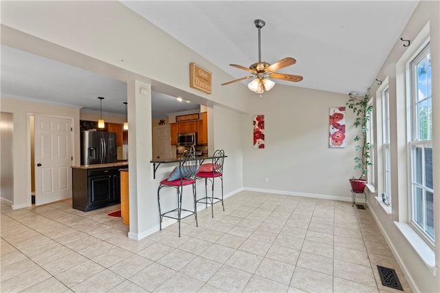 505 Luke Ct, Cranberry Twp, PA 16066 - kitchen featuring stainless steel appliances, light tile patterned floors, a ceiling fan, vaulted ceiling, and a breakfast bar area