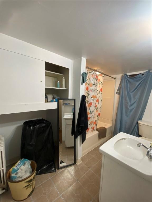 bathroom with vanity, toilet, and shower / bath combination with curtain