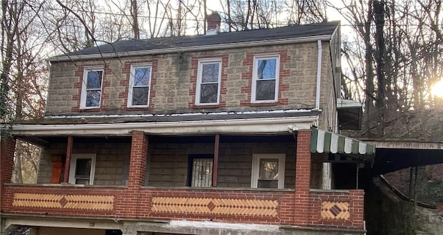 view of side of home featuring a chimney