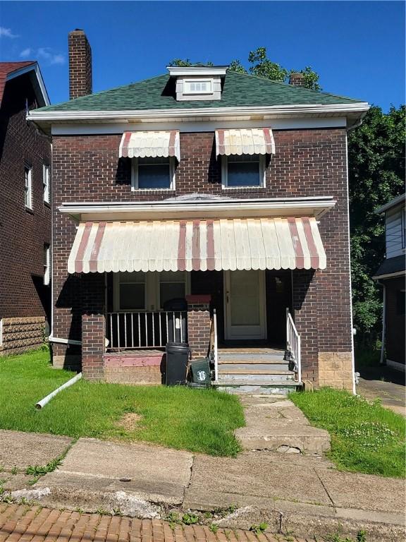 2615 Belmar Pl, Swissvale, PA 15218 - view of front facade with brick siding, a porch, and a chimney