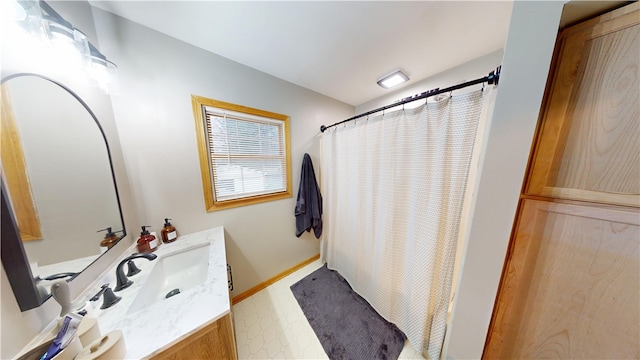 bathroom with tile patterned floors, vanity, a shower with curtain, and baseboards