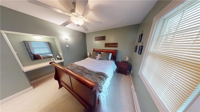 bedroom featuring light colored carpet, a baseboard radiator, baseboards, and a ceiling fan