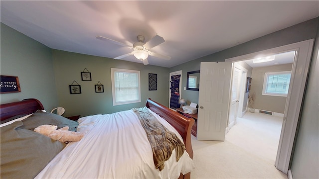 bedroom featuring light colored carpet and ceiling fan