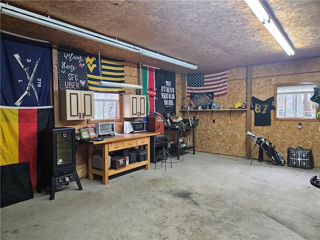 basement with a textured ceiling, healthy amount of natural light, and a workshop area