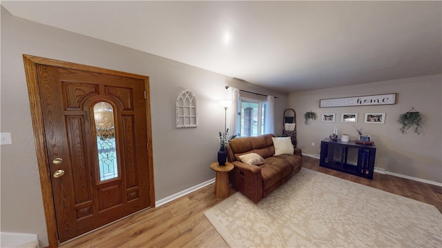 foyer featuring wood finished floors and baseboards