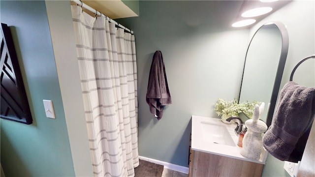 bathroom with vanity, baseboards, and curtained shower