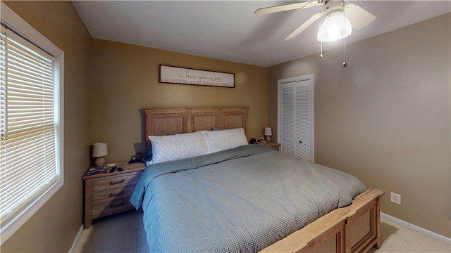 bedroom with a closet, multiple windows, baseboards, and light colored carpet