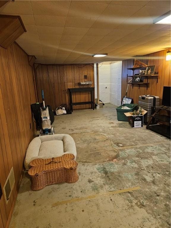 finished below grade area featuring wood walls