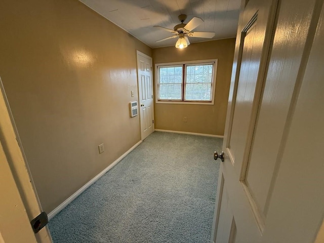empty room featuring carpet floors, ceiling fan, and baseboards