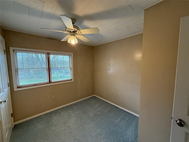 unfurnished room featuring a ceiling fan, carpet floors, and baseboards