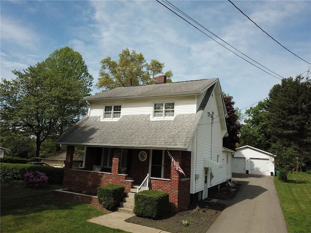 view of front facade featuring an outdoor structure, a garage, covered porch, a chimney, and a shingled roof