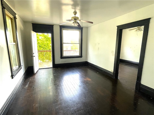 spare room with baseboards, wood-type flooring, and a ceiling fan