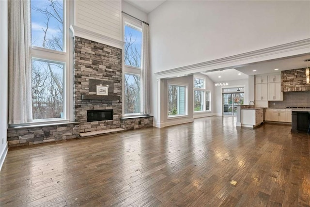 671 Chilliwack Ln, Marshall, PA 16046 - unfurnished living room with dark wood-type flooring, a high ceiling, a fireplace, and baseboards