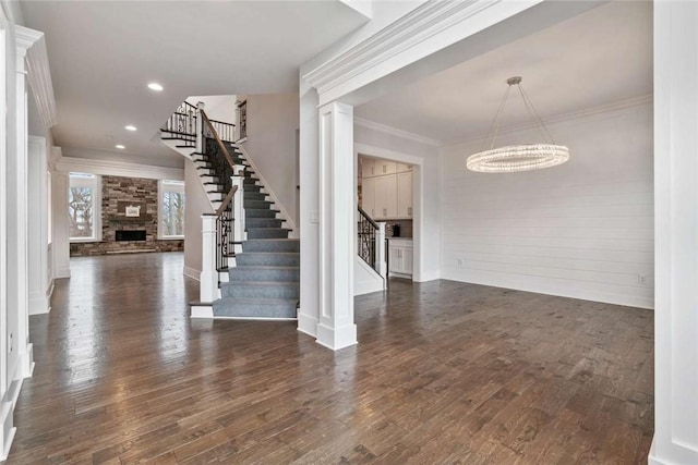 671 Chilliwack Ln, Marshall, PA 16046 - foyer entrance featuring dark wood-style flooring, ornamental molding, a chandelier, a fireplace, and stairway
