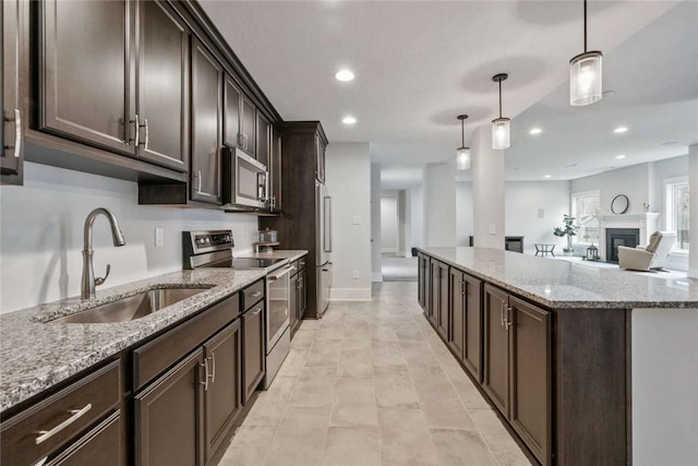 671 Chilliwack Ln, Marshall, PA 16046 - kitchen featuring decorative light fixtures, a sink, dark brown cabinets, and appliances with stainless steel finishes