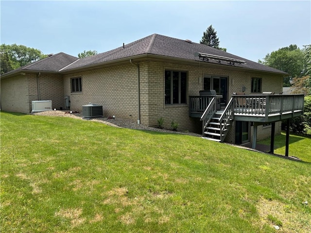 129 Lakeshore Dr, Center Twp But, PA 16001 - rear view of house featuring brick siding, a deck, a yard, and cooling unit