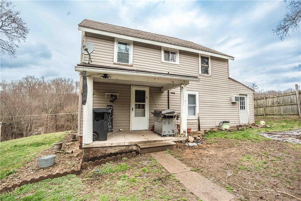 279 Stitt Hollow Rd, Manor Twp, PA 16226 - back of house featuring an AC wall unit, fence, and a patio